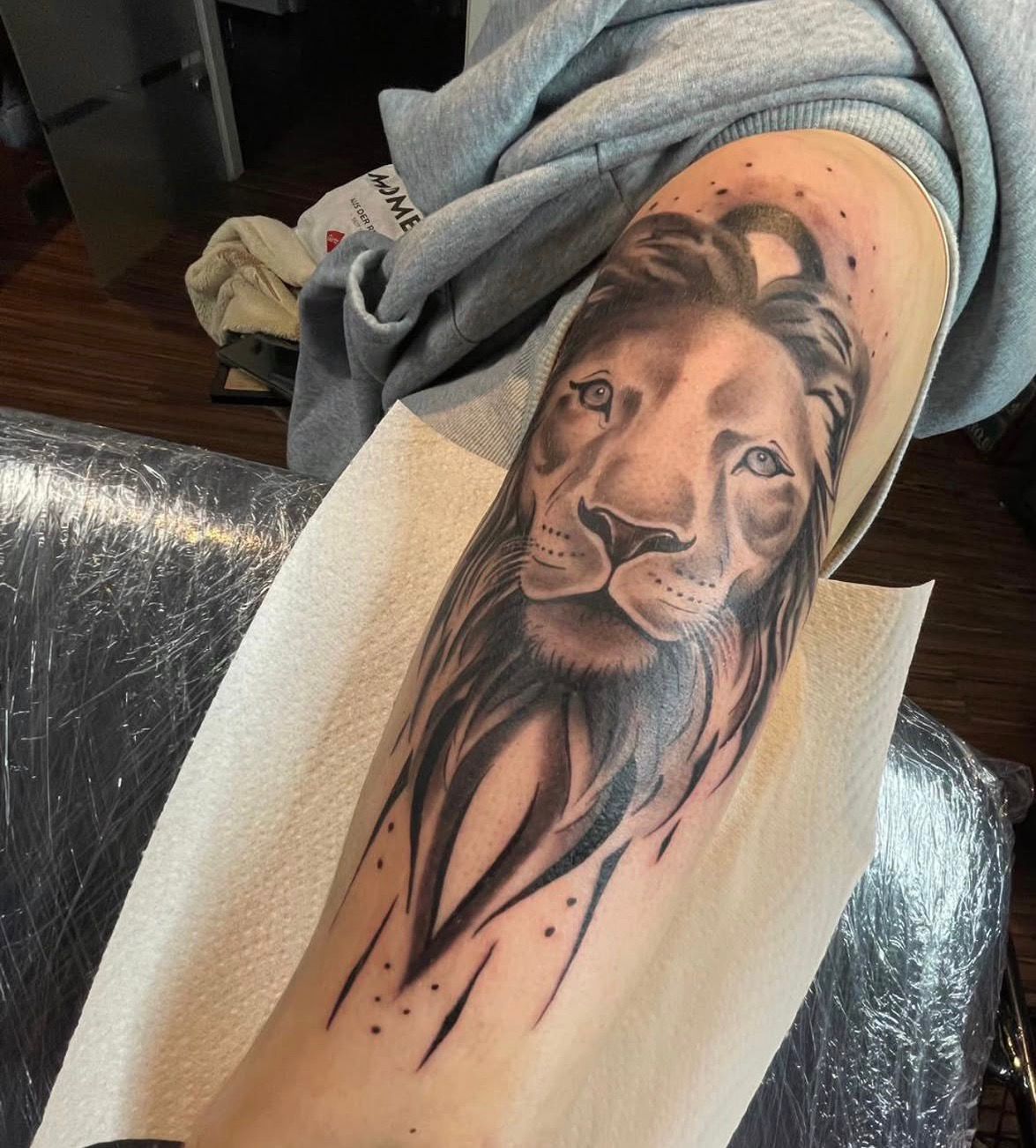 Black and Grey Tattoo mit ornamentalem Maskenmotiv